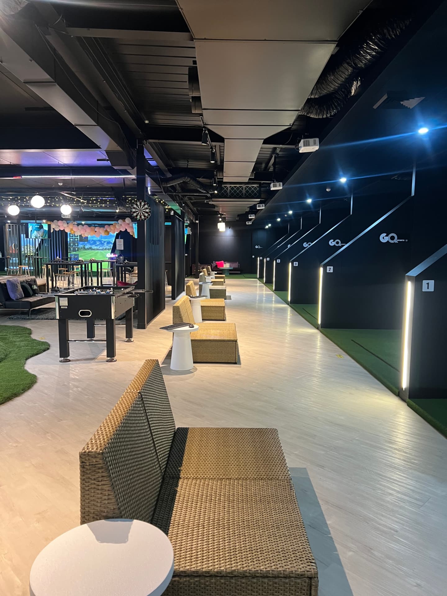 The Golf Q Meadowbank facility at NSW Meadowbank 2114, with 16 TrackMan IO bays, lounge seating and the entertainment area