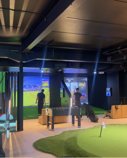 The putting green, foosball table and simulator bays at Golf Q Meadowbank